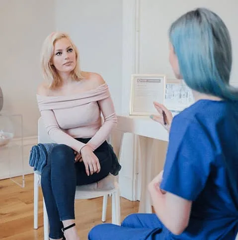 Patient sitting with a nurse in a bright consultation room at Cool Clinic, CoolSculpting fat freezing London